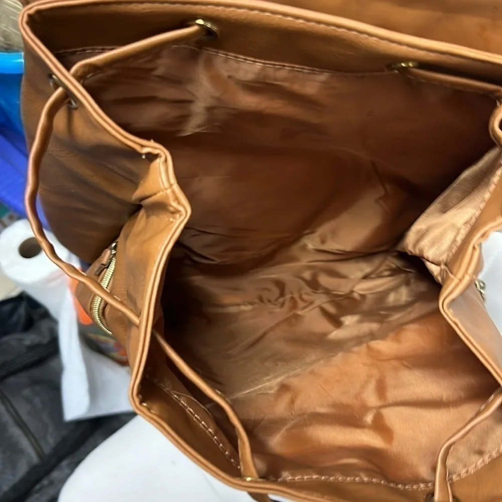 Brown backpack with zipper accented detailing on front, NWOT